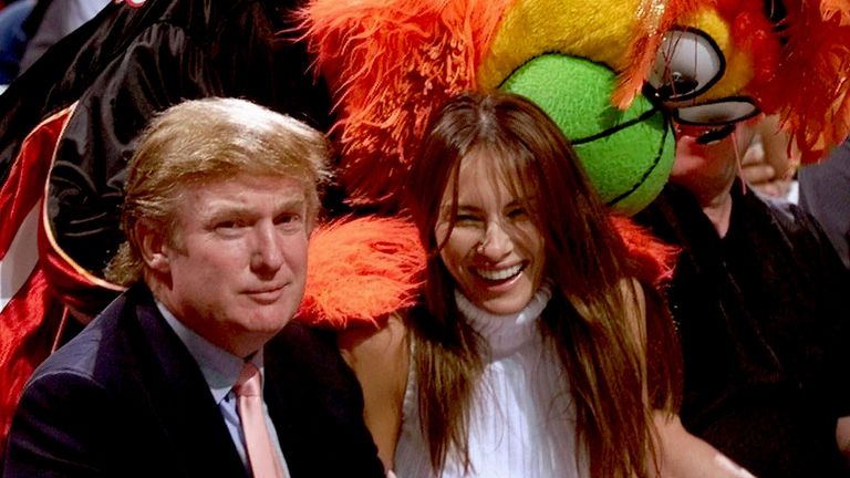 Real estate developer and Reform Party presidential hopeful Donald Trump sits with model Melania Knauss before the Miami Heat-Washington Wizards game  in 1999
Pic: Miami Herald/AP