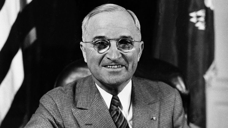 President Harry S. Truman sits at his desk in the White House in Washington, D.C., April 28, 1945, cheerfully obeying the mass request of some 100 photographers for "a big smile now, Mr. President," in the course of a field day for them as he sat for a battery of news and portrait cameras for 15 minutes. (AP Photo)