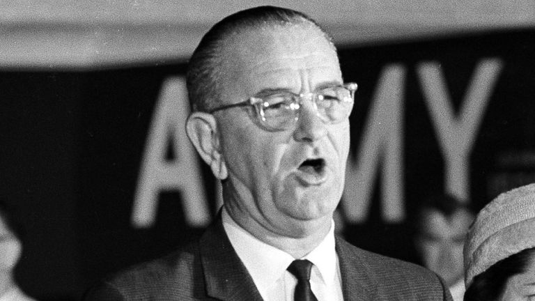 The new president of the United States, Lyndon B. Johnson, speaks at Andrews Air Force Base upon his return to Washington from Dallas, where President John F. Kennedy was shot to death, Nov. 22, 1963. Beside him is new first lady, Lady Bird Johnson. (AP Photo)