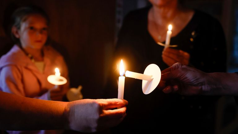 Lidé zapalují svíčky během vigilie za oběti střelby.   Obrázek: The Seattle Times/AP