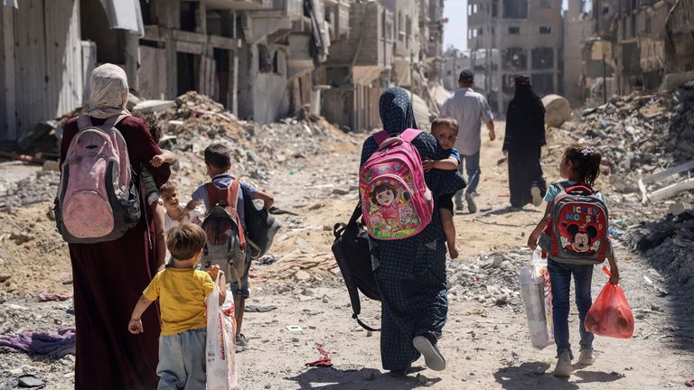 Palestinské ženy a jejich děti procházejí Džabalií v severní Gaze. Obrázek souboru: AP Photo/Enas Rami