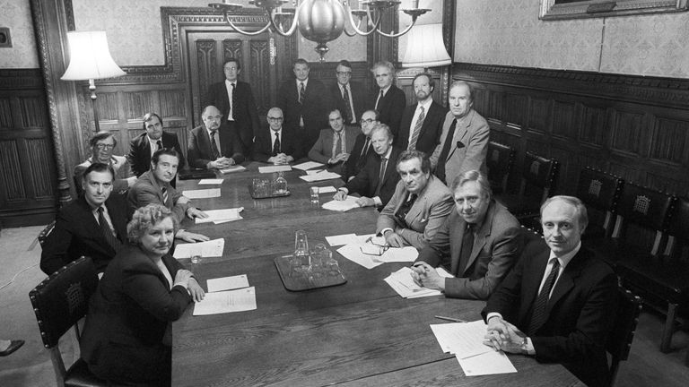 The first meeting of Neil Kinnock's Shadow cabinet at the House of Commons. Sitting from left: (clockwise) Gwyneth Dunwoody, Barry Jones, Peter Archer, Lord Cledwyn, John Prescott, Michael Cocks, Jack Dormand, John Cunningham, John Smith, Peter Shore, Denis Healey, Roy Hattersley, Neil Kinnock. Standing, from left: Michael Meacher, Eric Heffer, Lord Ponsonby, Giles Radice, Robin Cook, and Stan Orme