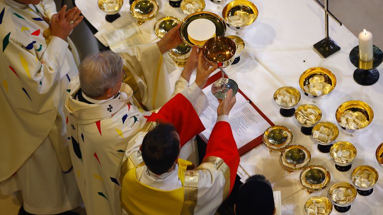 Arcibiskup Laurent Ulrich, uprostřed, vede eucharistii obklopenou duchovními po vysvěcení oltáře během inaugurační mše u příležitosti znovuotevření katedrály po její obnově, v Paříži, Francie, neděle 8. prosince 2024. (Sarah Meyssonnier/Pool Foto přes AP)