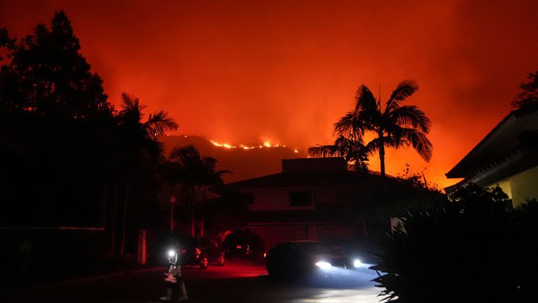 Osoba evakuuje rezidenci na Pepperdine University, když se Franklinův požár blíží v Malibu v Kalifornii, úterý 10. prosince 2024. (AP Photo/Jae C. Hong)