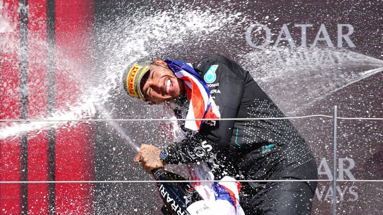 Mercedes' Lewis Hamilton celebrates winning on the podium at Silverstone Circuit, Northamptonshire. Picture date: Sunday July 7, 2024.