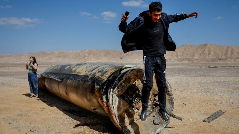 A man jumps off apparent remains of a ballistic missile lying in the desert, following an attack by Iran on Israel, near the southern city of Arad, Israel October 2, 2024. REUTERS/Amir Cohen          SEARCH "REUTERS BEST 2024" FOR THIS STORY. SEARCH "REUTERS YEAR-END" FOR ALL 2024 YEAR END GALLERIES.          TPX IMAGES OF THE DAY