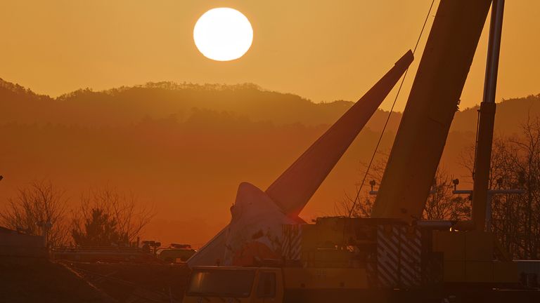 První východ slunce na Nový rok je vidět poblíž místa letecké havárie na mezinárodním letišti Muan v Muan, Jižní Korea, ve středu 1. ledna 2025. (Son Hyung-ju/Yonhap přes AP)