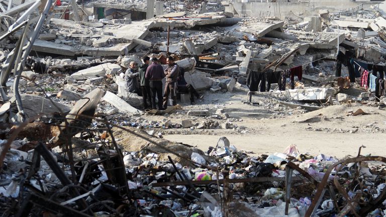 Palestinci stojí mezi troskami domů zničených při předchozích izraelských úderech ve městě Gaza.  Snímek: Reuters