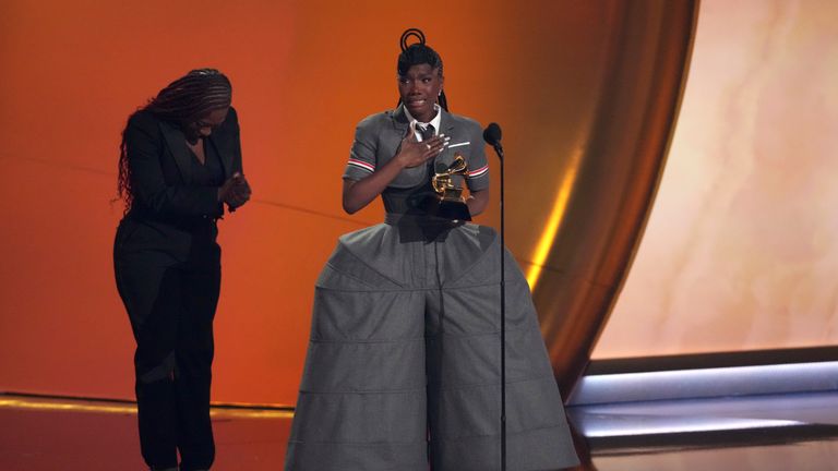 Doechii, center, accepts the award for best rap album for "Alligator Bites Never Heal" during the 67th annual Grammy Awards on Sunday, Feb. 2, 2025, in Los Angeles. Celesia Moore looks on from left(AP Photo/Chris Pizzello)