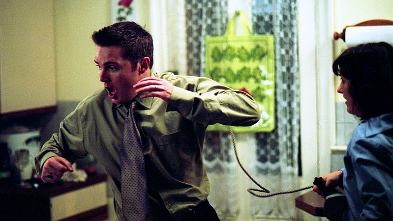 Little Mo (Kacey Ainsworth) hits Trevor with an iron in EastEnders on New Year's Eve 2001. Pic: BBC