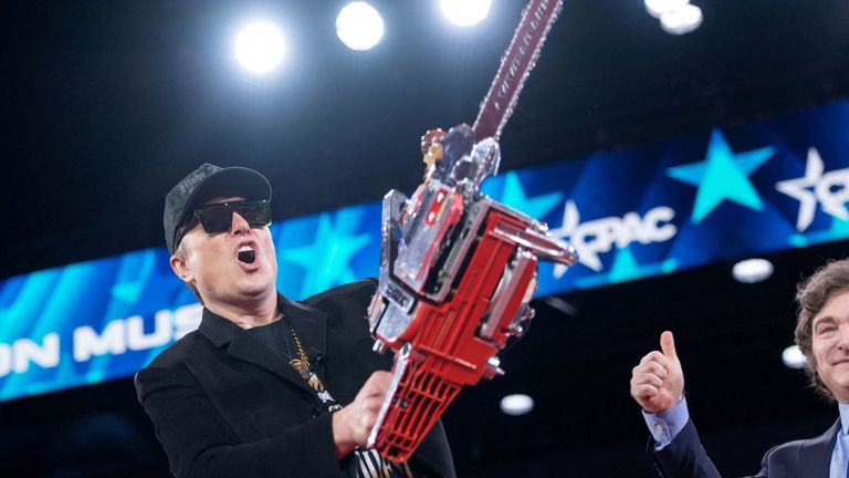 Elon Musk holds a chainsaw gifted by Argentina  president Javier Milei during the Conservative Political Action Conference.
Pic: Reuters