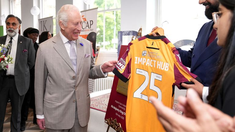 King Charles je představen košili Bradford City, když navštěvuje Impact Hub Yorkshire.  Pic: Reuters