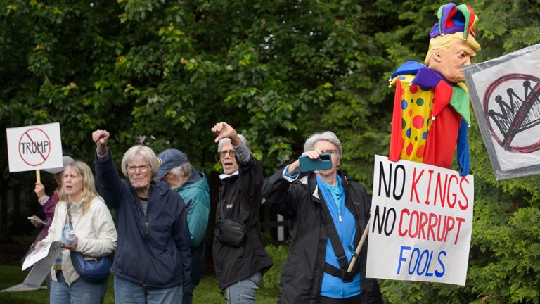Demonstranti protestují poblíž národního golfového klubu Trump před příjezdem prezidenta.   Pic: AP/ROD LAMKEY JR