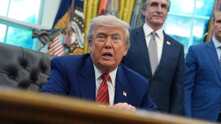 Prezident Donald Trump hovoří s reportéry po podpisu výkonných příkazů týkajících se jaderné energie v Oválné kanceláři Bílého domu v pátek 23. května 2025 ve Washingtonu, jako ministr obchodu Howard Lutnick a ministr obrany Pete Hegseth poslouchá. (AP Photo/Evan Vucci)