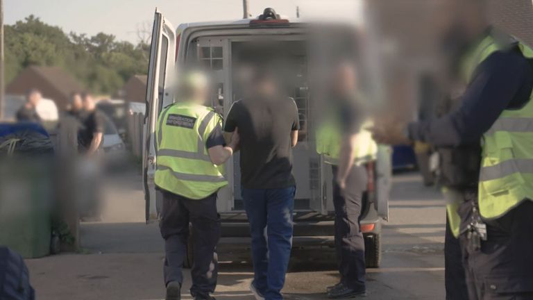 Po podezření se po zatčení v Surrey je veden do dodávky. Pic: Home Office