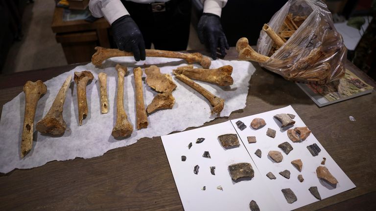 Hassan Ismail z Idlib Museum zkoumá kosti z byzantského podzemního hrobkového komplexu nalezeného v Maarat al-Numan v Sýrii. Pic: Ap