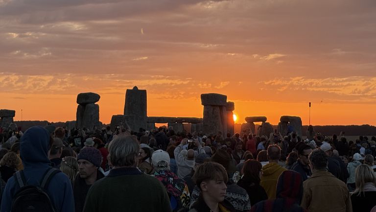 Lidé se shromažďují, aby sledovali, jak slunce stoupá na Stonehenge ve Wiltshire. Pic: Pa