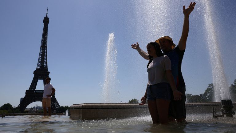 Turisté se ochladí ve fontáně Trocadero vedle Eiffelovy věže, když začátkem letního vlny zasáhla Paříž ve Francii, 1. července 2025. Reuters/T