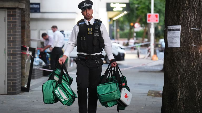 Policejní důstojník odstraňuje lékařské tašky ze scény v Long Lane, Southwark v jižním Londýně, kde byli dnes dříve bodnut čtyři lidé. Pa