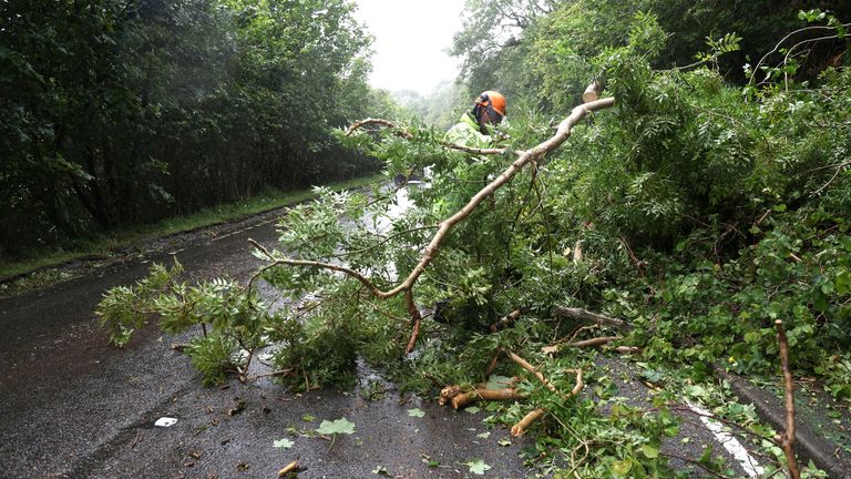 Pracovník odstraní padlý strom blokující část silnice A82 poblíž Onich, protože Storm Floris zasáhne Skotsko.  Obrázek: Reutetrs
