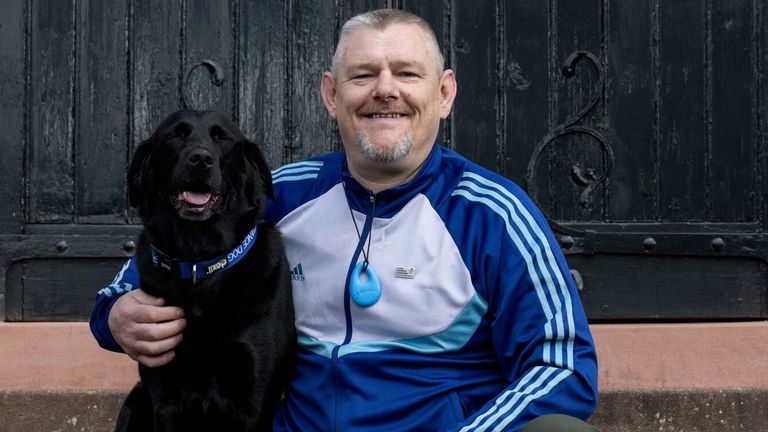 John Davidson Mbe, se svým černým labradorem Suki. Pic: Studiocanal 